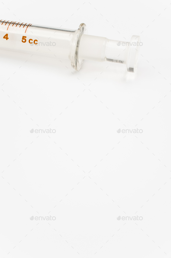 isolated sterilized glass injection syringe on a white paper background