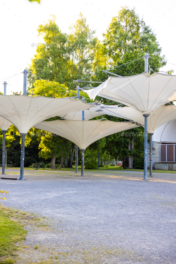 Small stage with umbrellas in the city garden of Constance, Germany