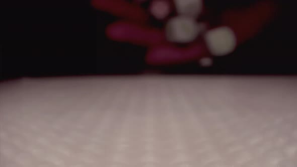 The Slow Motion of Rolling Gaming Dices on Light White Poker Table alt