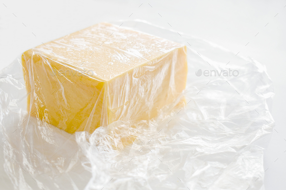 Cheese wrapped in cling film or plastic wrap.