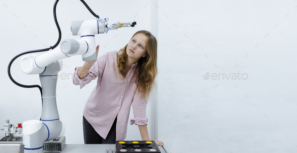 Girl caucasoid education electronic robotic arm on table at class room. learning innovation.