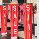 Red sale word banner at clothing store entrance. Seasonal discount offer in store - PhotoDune Item for Sale