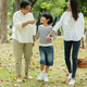 Happy Asian family spending time together outside in park, vacation of parents concept - PhotoDune Item for Sale