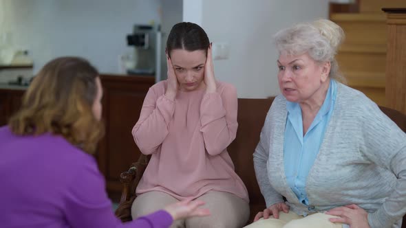 Portrait of Depressed Frustrated Caucasian Young Woman Closing Ears with Hands As Mother and alt