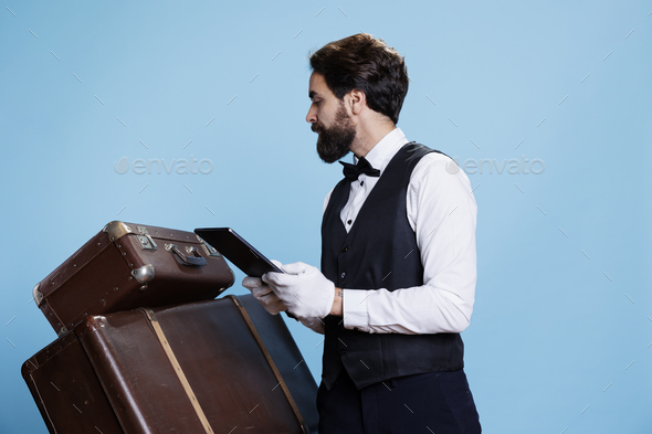 Hotel concierge counting trolley bags