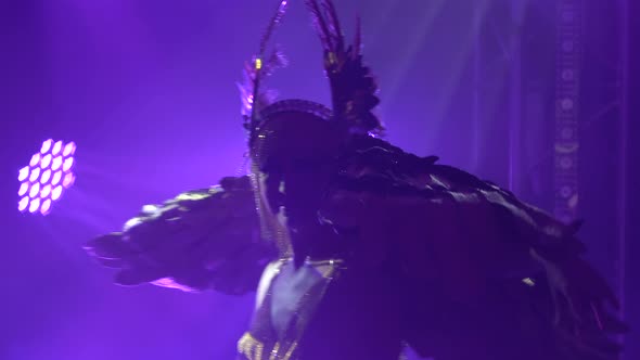 Silhouette of a Dancing Woman with Wings on Her Back. Greek Goddess Artemis in a Theatrical Vocal alt