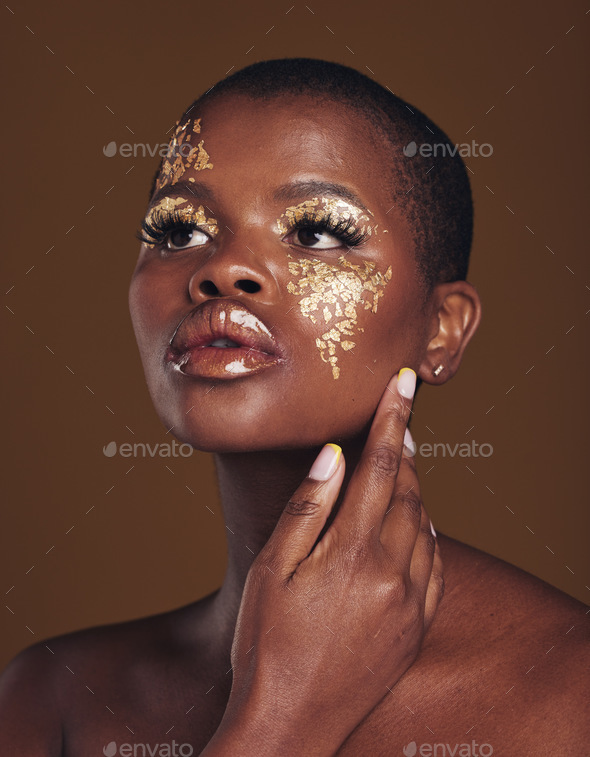 Art, aesthetic and black woman with gold makeup and brown background with glitter, paint and cosmet