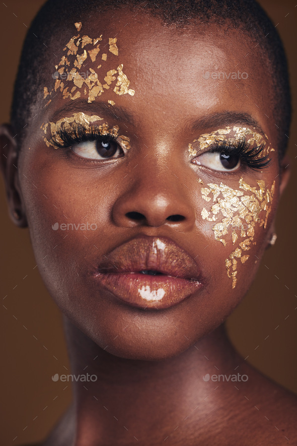 Art, beauty and black woman with gold makeup on brown background