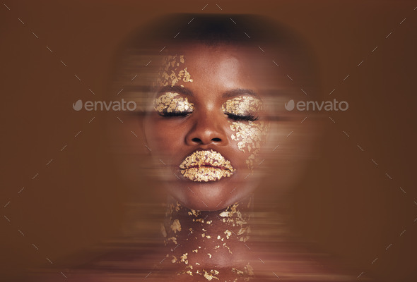 Blurred beauty, black woman with gold makeup and brown background