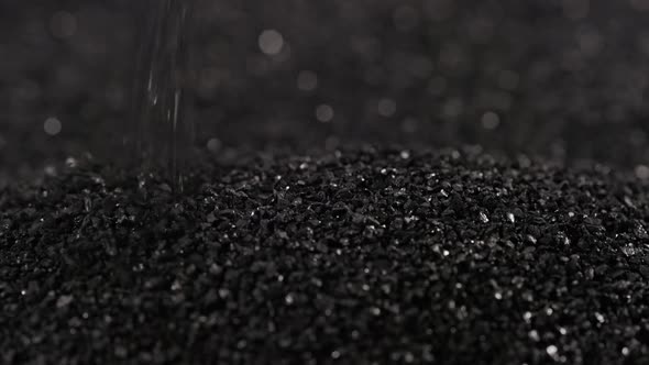 Pouring Black Coconut Charcoal Closeup Slomo Activated Carbon Small Fraction alt