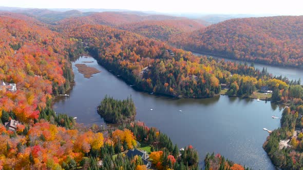 Aerial view of a lake and fall season foliage colors.