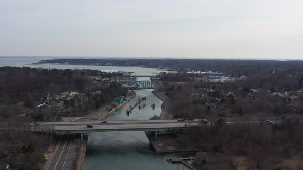 An aerial view over the Shinnecock Canal in Hampton Bays, Long Island, NY. The drone camera dolly in alt