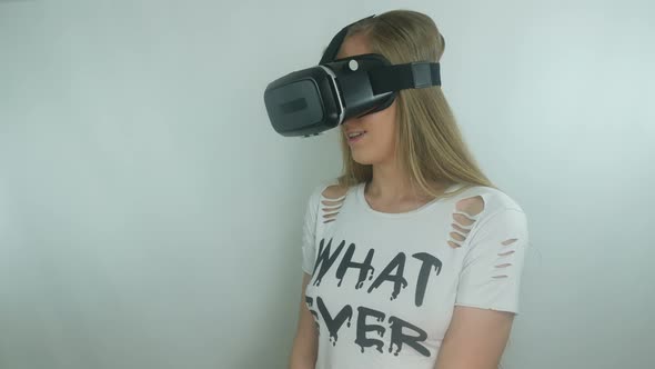 Young Girl Uses A Modern Virtual Reality Helmet alt