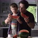 Father and son eating watermelon in kitchen - VideoHive Item for Sale