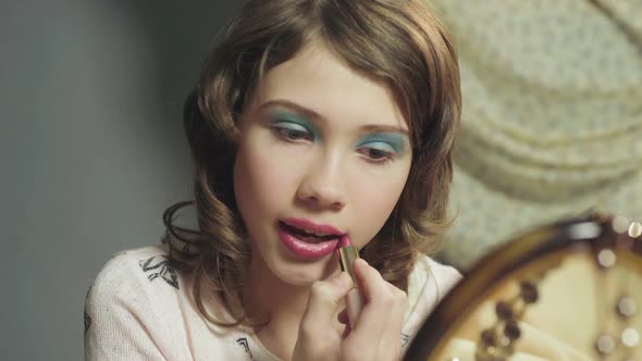 Adolescent Girl Casually Painting Her Lips with Moms Lipstick, Rebellious Child alt