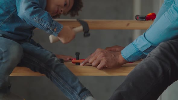 Dad Teaching Little Boy Using Toy Work Tools alt