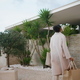 Woman walking modern house in evening. Stylish african american entering home - PhotoDune Item for Sale