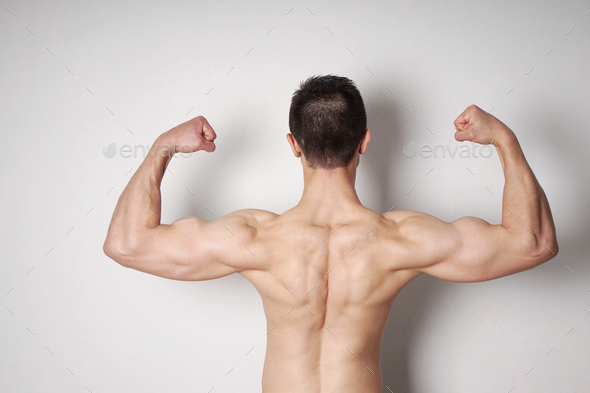 man flexing biceps and back muscles Stock Photo by axelbueckert