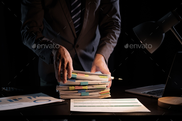 Business Employee hand working in Stacks paper files for searching and check unfinished document arc - Stock Photo - Images