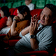 Close up Asian man look scary or panic during watch movie with his family in cinema theater - PhotoDune Item for Sale