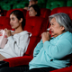 Asian senior woman look scary or panic during watch movie in cinema theater - PhotoDune Item for Sale