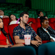Group of multiethic people sit on seats in cinema theater and they look boring during watch movie - PhotoDune Item for Sale