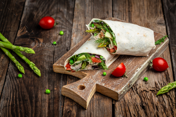 Wraps with chicken and asparagus, avocado, tomatoes, peas, cheese and tartar sauce