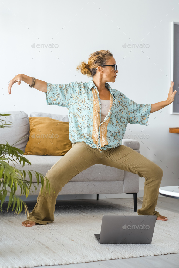 One woman in wellbeing indoor leisure activity oriental exercises. Female stand up