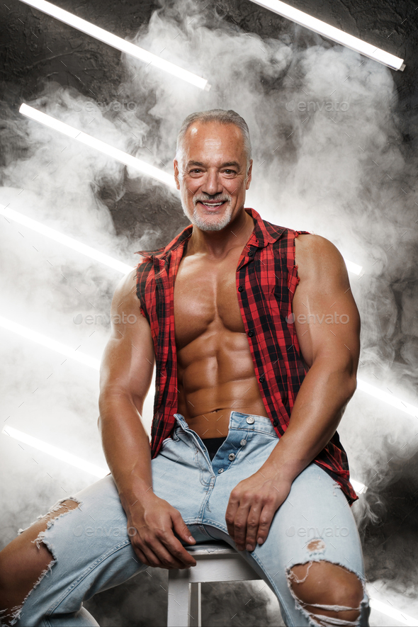 Masculine middle-aged male model with chiseled torso grey beard and bare chest