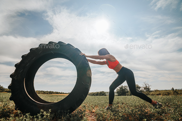 CrossFit Training Female Athlete Demonstrating Strength with a Wheel Lift