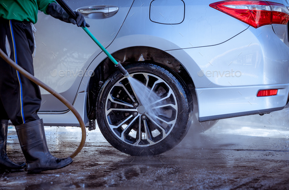 Car care worker wash and clean car with high pressure washer outside for clear dirty dust ,car servi