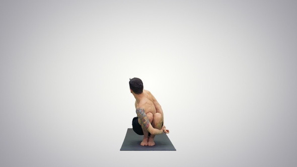 Young man doing squat with twist and bend yoga on gradient alt