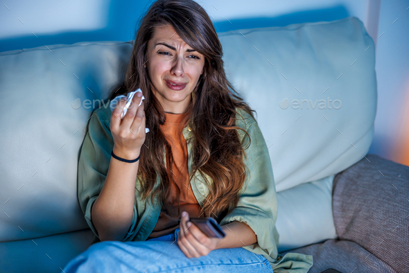 Woman watching drama movie on TV and crying