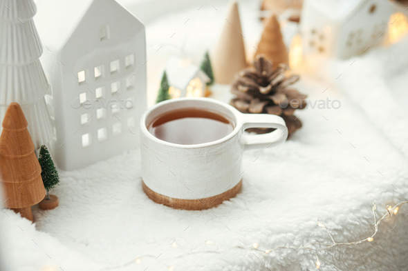 Cozy winter still life. Stylish cup of tea with cozy knitted