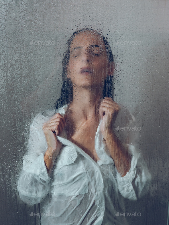 Charming woman standing in shower cabin