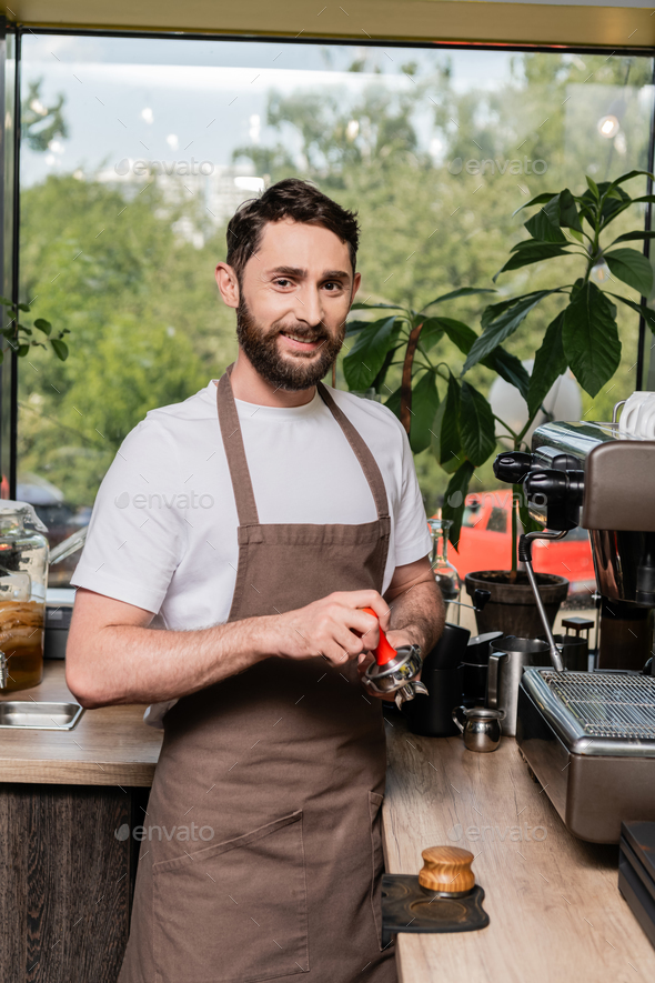 barista holding tamper near portafilter with grinded coffee, espresso, manual  press Stock Photo by LightFieldStudios