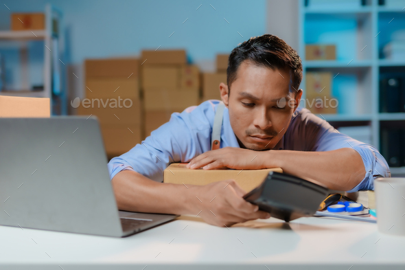 Asian male business owner stressed and uneasy surrounded by boxes. business bankruptcy concept.