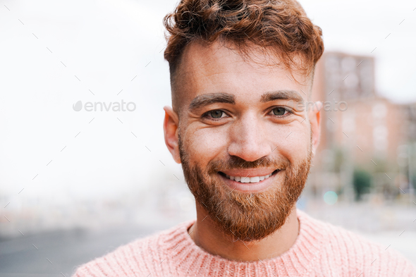 Happy ginger hair man smiling on camera outdoor - Diversity community concept