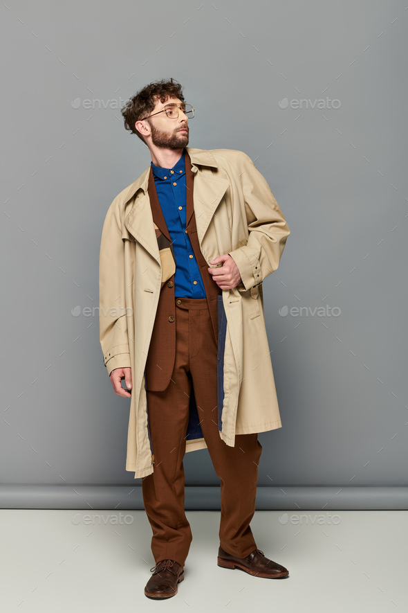 Young Bearded Man In Long Coat Is Posing With One Hand In His Pocket Stock  Photo, Picture and Royalty Free Image. Image 23422864.