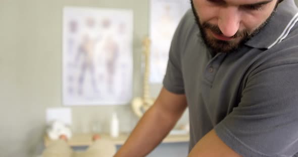 Physiotherapist giving back massage to a woman alt