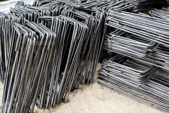Steel bars piled up in front of construction site work