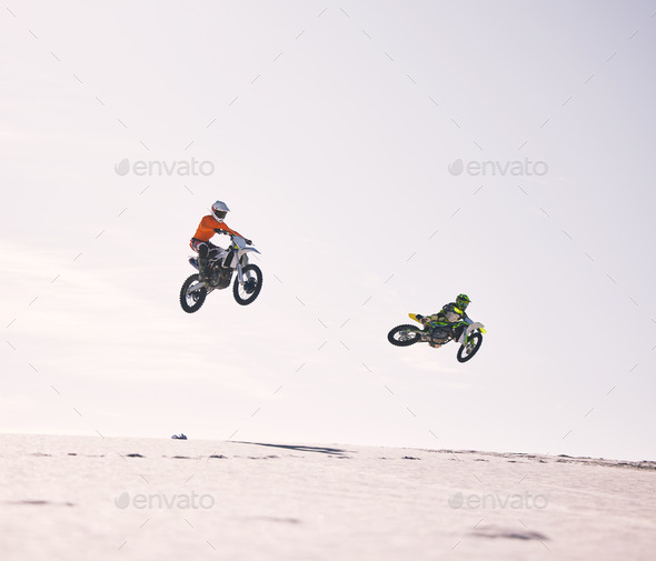Dune, jump and men on motorbike together for practice, training and extreme sports energy in nature