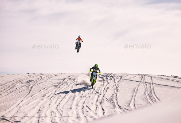 Dune, jump and men in motorbike race together for practice, training and extreme sports energy. Pro