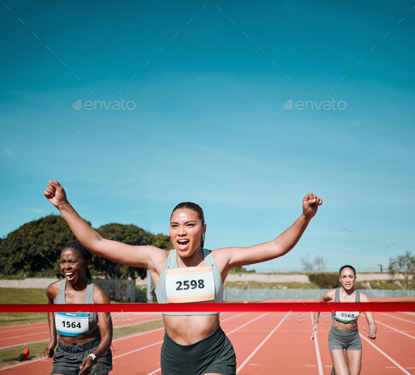 Happy woman, running and winning by finish line in competition, race or marathon on outdoor stadium