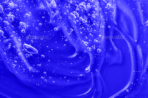 Cosmetic blue gel texture with bubbles. Hyaluronic acid clear serum sample. Liquid antibacterial