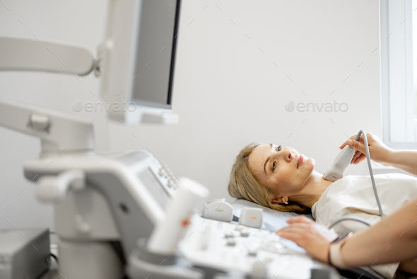 Adult woman during an ultrasound diagnosis of thyroid