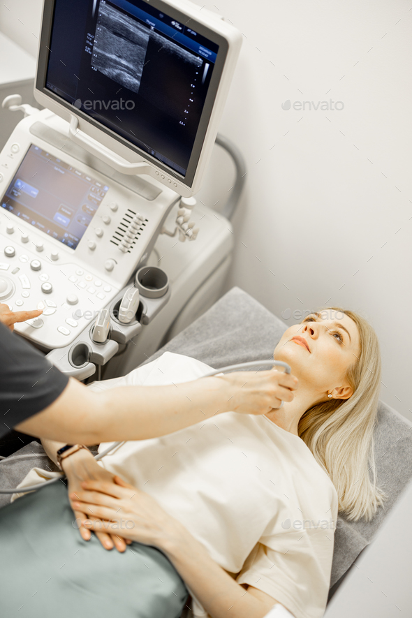 Adult woman during an ultrasound diagnosis of thyroid