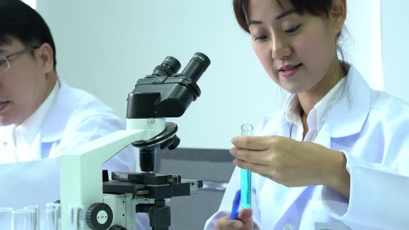 Scientists experimenting with chemicals alt