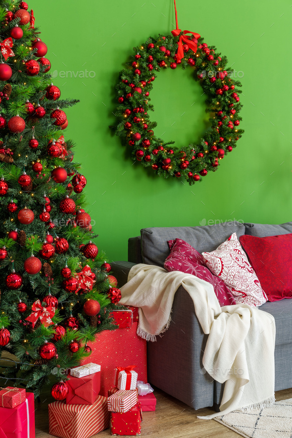 Christmas living room interior with sofa, Christmas tree and wreath on