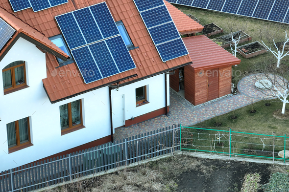 Private home roof covered with solar photovoltaic panels for generating of clean